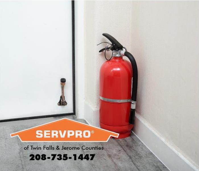 A portable fire extinguisher is shown in a home. 