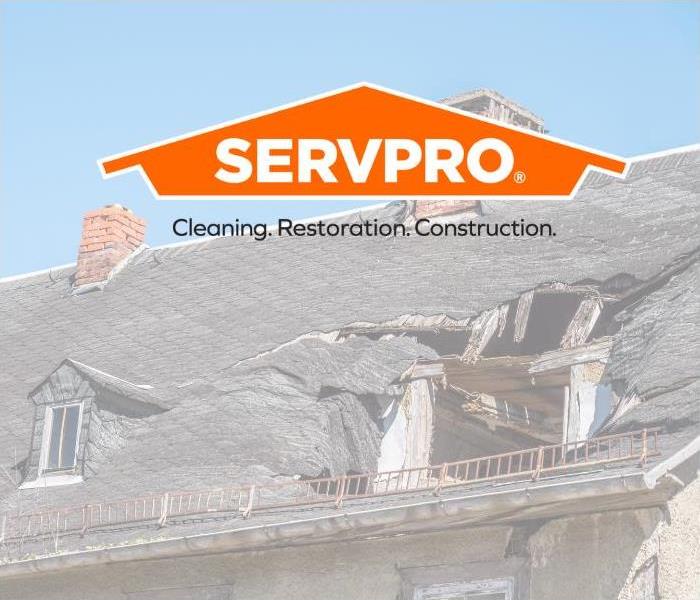 Damaged roof with SERVPRO logo 